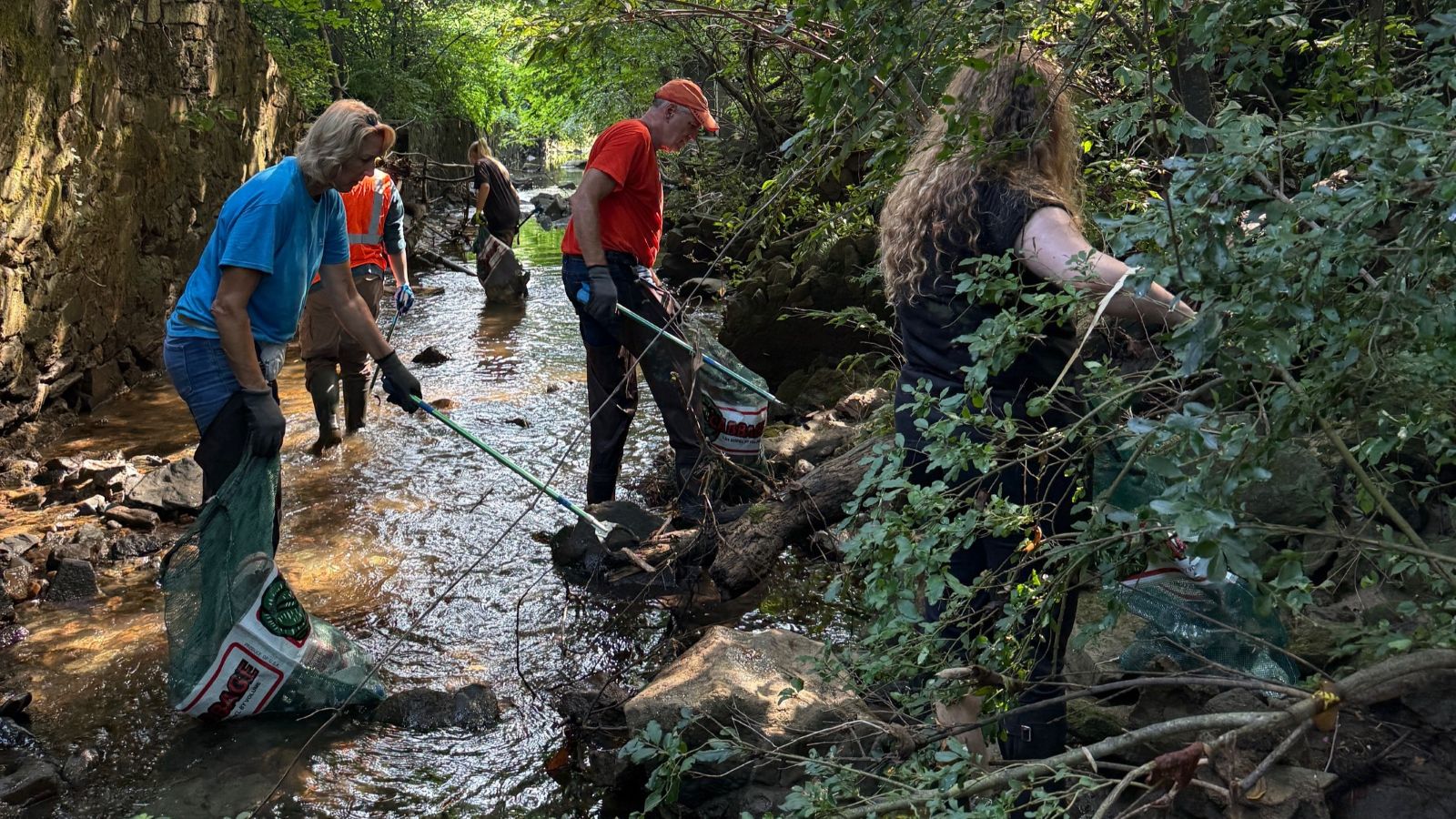 volunteers cleaning up in the stream